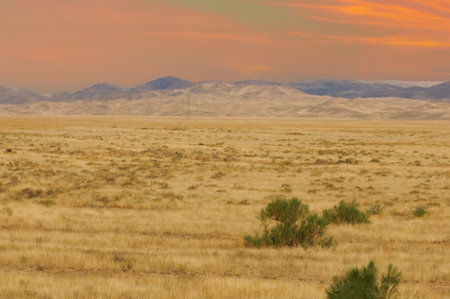 Steppe, prairie, Behold the breathtaking combination of craggy mountain peaks and arid desert plains, creating a spectacular portrait of nature's beauty.の写真素材