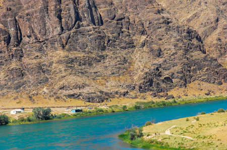 The refreshing water is ideal for cooling off in the summer heat. The natural beauty of the flowing river complements the scenic views. Opportunities for swimming, fishing and walking along the banksの写真素材