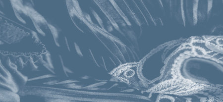 Undulating folds of silk-like fabric create a mesmerizing landscape of cascading pleats, reflecting soft light and adding depth, movement, and a serene sense of fluidity.の写真素材