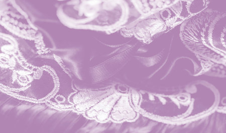 Intricate baroque-inspired appliques bloom across gently gathered silk, showcasing fine needlework and lustrous highlights in a serene purple palette that radiates sophistication.の写真素材