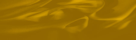 Flowing amber-toned cloth envelops the frame with gentle curves, accentuating every crease and fold. Subtle interplay of light and shade lends an inviting, luxurious warmth.の写真素材