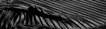 Rippling velvet folds blend with ornate embroidery in this striking monochrome image, revealing subtle variations in tone and texture, evoking a sense of understated luxury.の写真素材