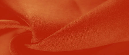 The fabric is a burgundy red. The image captures the swirl of the fabric, suggesting movement and softness. The highlights and shadows are more pronounced, giving it a dynamic look.の写真素材