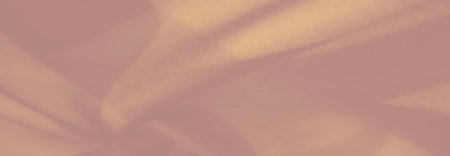 An fabric draped gracefully, showing its luxurious sheen and flowing folds. The soft texture exudes refinement and artistic charm.の写真素材