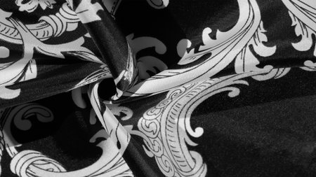 Black and white silk fabric with monogram. Exquisite filigree fabric pattern. texture, backgroundの写真素材