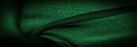 Sheer dark green chiffon silk, Emerald abstract background. Green fabric closeup. - it is a soft transparent fabric with a slight roughness (matte, crepe) due to the use of twisted yarn. textureの写真素材