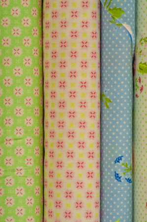 Mix fabrics. Shop counter. Many fabrics of different types. View from above. Printed, cotton, mixed...