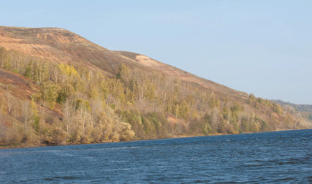 utumn landscape, autumn view of the Kama. Fantastic autumn scene with bright sky, majestic rocky...