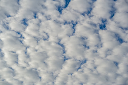 Broken dawn. "Crimson clouds", strong red and pink streaks indicate tall clouds reflecting light at sunrise or sunset.の写真素材