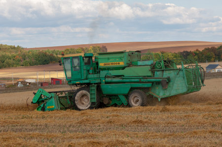 Summer photo of barley harvesting, Combine harvester, a machine commonly used for harvesting grain...