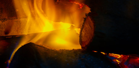 Fire in the fireplace. Our ancestors discovered that fire repelled saber-toothed tigers, and the area around them became a safe place. It has become a social spaceの写真素材