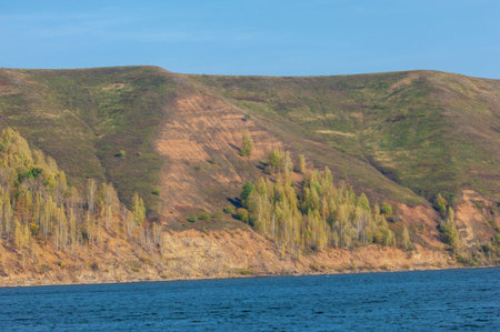 Photo of an autumn landscape, Picturesque autumn landscape of steady river and bright trees.の写真素材