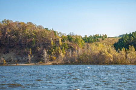 Autumn landscape banner, beautiful landscape with high river bank, reflection, blue sky and yellow sunlight at sunrise. The Kama river. Tatarstan. Russiaの写真素材