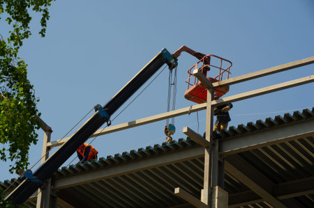 Workers on the construction site with blue sky in the background.