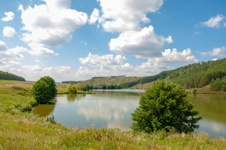 Summer landscape photography, rolling hills with a lake, Central Europe
