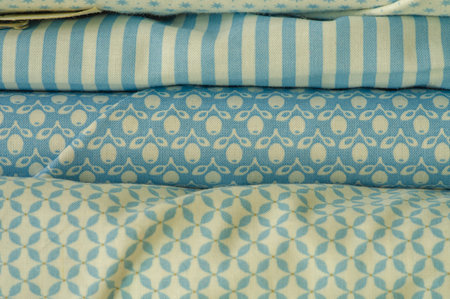 Mix fabrics. Shop counter. Many fabrics of different types. View from above. Printed, cotton, mixed...