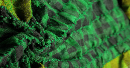 Texture, background, pattern. A woolen scarf to be worn around a person's neck. Green black color on...