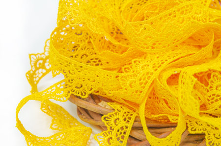 Add pops of color to any outfit with a yellow lace ribbon. Give new life to old clothes with this trendy finish. Easy to sew on or stick to clothes and accessories.の写真素材