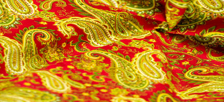 Paisley green pattern on a red background. decorated the bandanas of cowboys and bikers popularized...