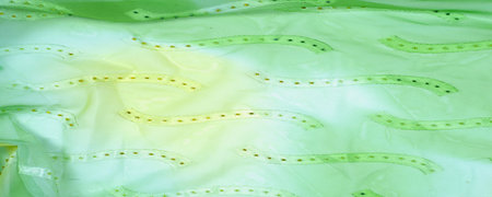 Seamless kaleidoscope. Fabric silk green-blue shades. Vibrant colors and scalloped shapes create a...