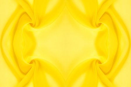 background seamless texture - yellow silk. Premium silk organza in pale yellow is an exceptional fabric, beautiful both on its own and as an accessory in terms of highlighting.の写真素材