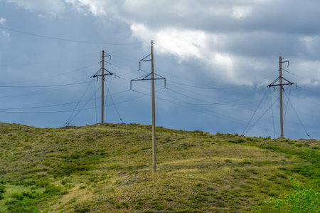 Enjoy the beauty of the steppe prairies in summer. Capture stunning shots of high voltage pylons against the backdrop of the landscape. Enjoy outdoor activities like hiking and picnicsの写真素材