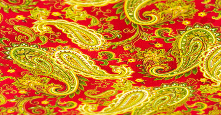 Paisley green pattern on a red background. decorated the bandanas of cowboys and bikers popularized by The Beatles, ushered in the era of hippies and became the emblem of rock and roll.の写真素材