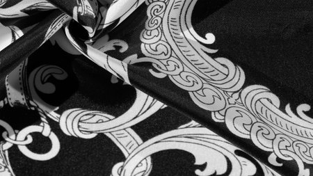 Black and white silk fabric with monogram. Exquisite filigree fabric pattern. texture, backgroundの写真素材