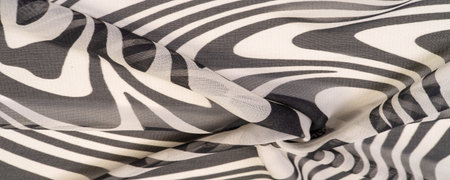 silk fabric, black and white abstract lines. The magical shape of an abstract black and white...