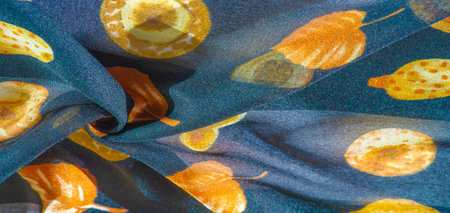 Silk fabric, blue with a print of yellow autumn leaves. Texture, background pattern