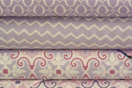 Mix fabrics. Shop counter. Many fabrics of different types. View from above. Printed, cotton, mixed...