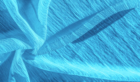 Silk fabric. Texture of blue wrinkled fabric. Blue wrinkled, wavy surface texture. Close-up, soft focus. background, patternの写真素材