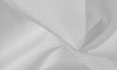 Silk is white. White gray satin texture, it is silver fabric, silk panorama, background with...