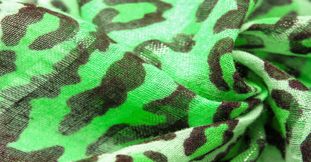 silk fabric green yellow with leopard print. Lightweight leopard print silk is perfect for your design, looks stylish and not vulgar! Texture, background, patternの写真素材