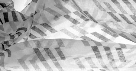 White silk fabric with black geometric rhombus shapes. dark. Background. Template.の写真素材