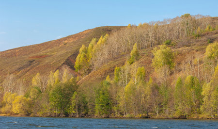 Photo of an autumn landscape, an almost perfect reflection of the Rocky Mountains in the Kama River. Near Kazan, Tatarstan, Russia. The winter season is approaching.の写真素材