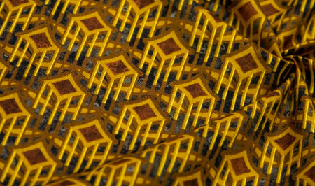 Thick cotton fabric with diamond print on yellow lines. On a gray background. Texture. Drawing. abstract geometric pattern with yellow, gray, brown diagonal, zigzag stripes, geometric backgroundの写真素材