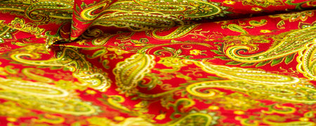 Paisley green pattern on a red background. decorated the bandanas of cowboys and bikers popularized by The Beatles, ushered in the era of hippies and became the emblem of rock and roll.の写真素材