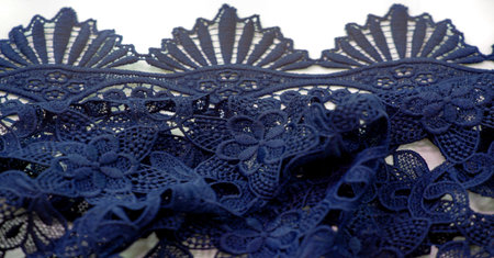 Lace fabric in blue. Pure cotton lace with floral pattern embellished with embroidery. Light...