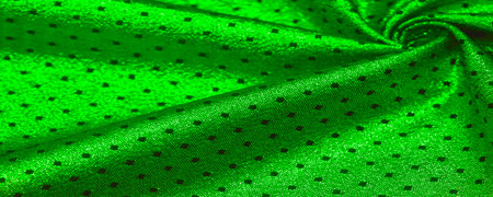 Fabric with a metallic sheen in small polka dots. Green color Be the center of attention at your next event with a striking metallic fabric design that delivers an incredibly smooth and vibrant sheenの写真素材