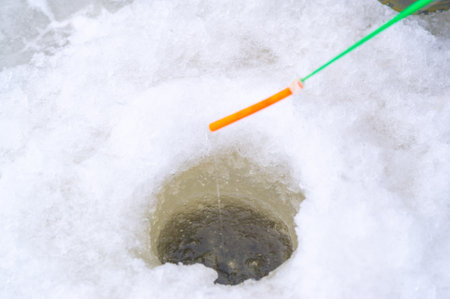 Winter ice fishing. Ice fishing is a great way to pass the time during the winter months and gives anglers the chance to catch some truly trophy fish.の写真素材