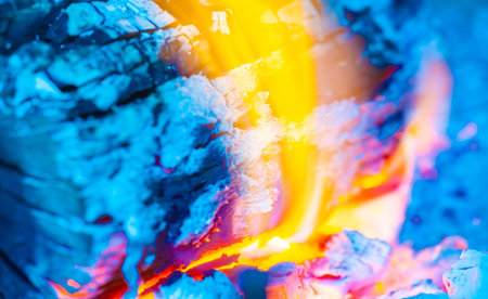 The flame creates a warm and cozy atmosphere Burning wood is energetic and bright Create a cozy atmosphere with a bright flame of burning woodの写真素材