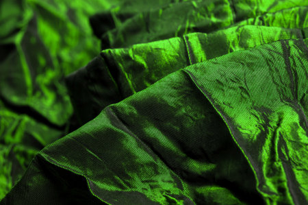 Green silk fabric. It is a beautiful and regal silk fabric. It has a duller sheen than regular satin on one side, is of medium weight, and is more durable to the touch.の写真素材