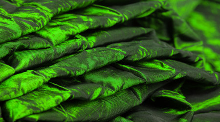 Green silk fabric. It is a beautiful and regal silk fabric. It has a duller sheen than regular satin on one side, is of medium weight, and is more durable to the touch.の写真素材