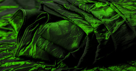 Green silk fabric. It is a beautiful and regal silk fabric. It has a duller sheen than regular satin on one side, is of medium weight, and is more durable to the touch.の写真素材