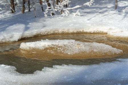 The river freezes in winter. Winter makes me think. As the sun rises later and sets earlier, the hours you can spend on the river are getting shorter.の写真素材