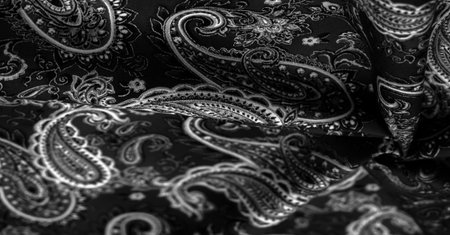 Paisley black-white pattern on a black background. decorated the bandanas of cowboys and bikers popularized by The Beatles, ushered in the era of rock and roll.の写真素材