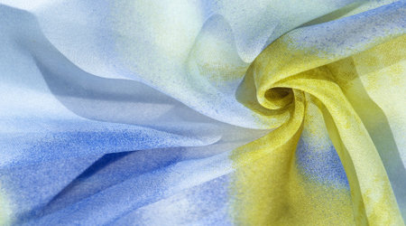 silk fabric in soft blue, yellow and white tones with abstract patterns and bed tones. Texture, pattern, collectionの写真素材