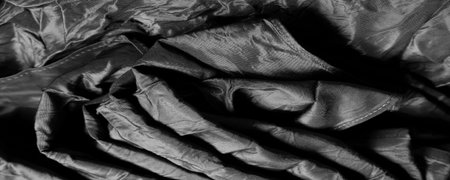 black silk fabric. This is the most luxurious silk crepe satin in the deepest shade of ebony. Using this designer fabric, you will feel undeniably luxurious as your design.の写真素材