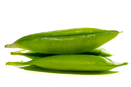 Aesthetic and visually appealing image with green peas on a white background Ideal for use in food design or advertising High quality and detailed photograph of fresh bright peasの写真素材